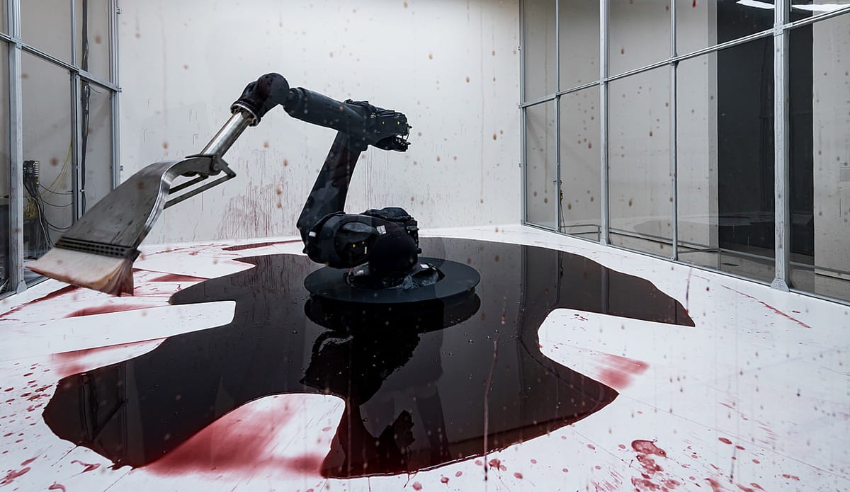 And industrial robot arm with a squeegee in a white and glass room surrounded by a pool of red, blood-like liquid.  Photograph