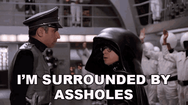 A screencapture from the movie "Spaceballs" featuring the character "Dark Helmet."  There is mem text saying "I'm surrounded by assholes."